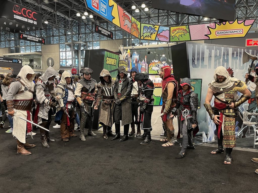 Group of Assassin's Creed cosplayers in hooded robes at New York Comic Con 2023