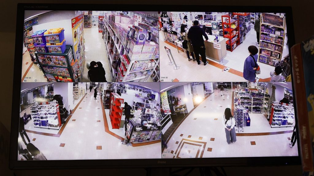 Wall-mounted security camera against a plain background