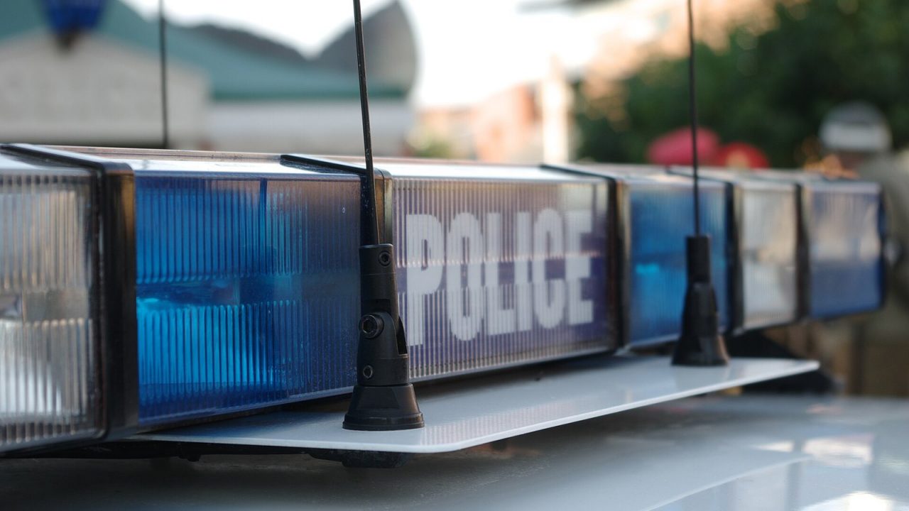 Flashing red and blue lights on a police car at night