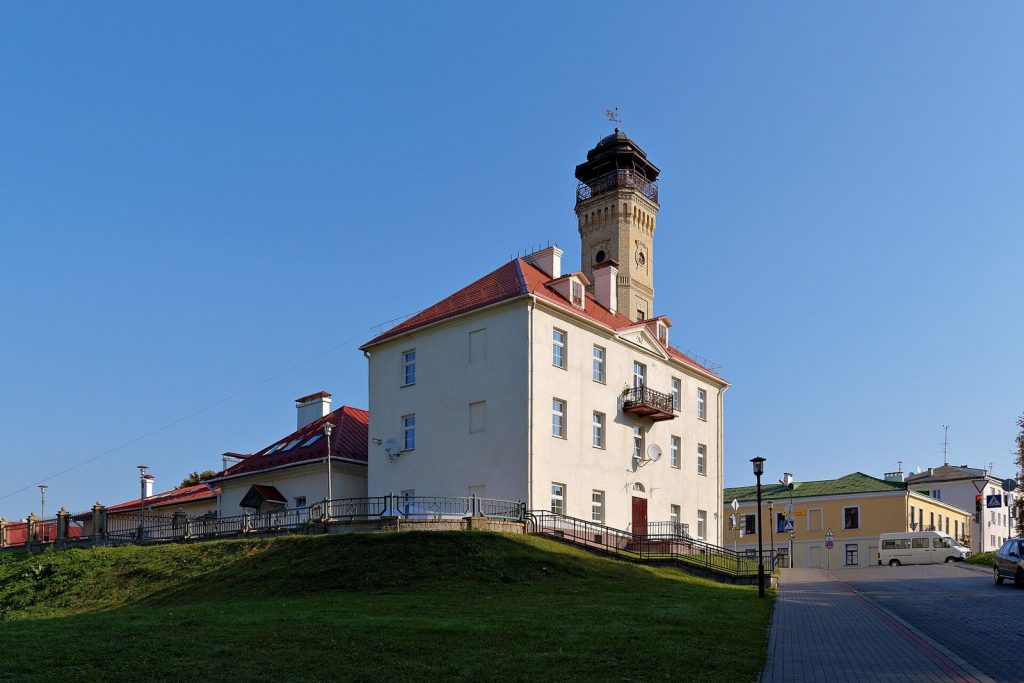 Tall historic fire lookout tower in Grodno rising above surrounding buildings